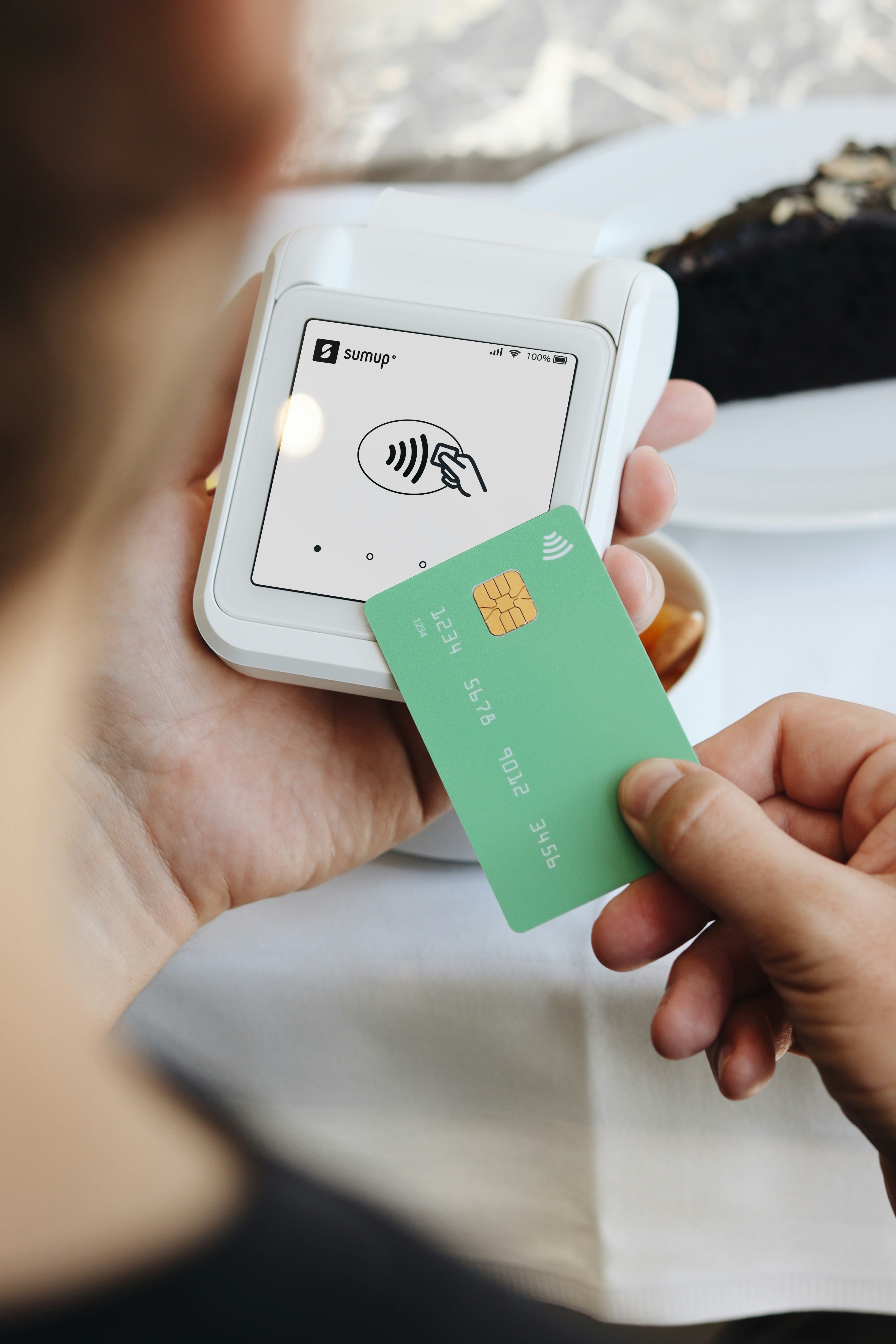 A person holding a credit card in their hand